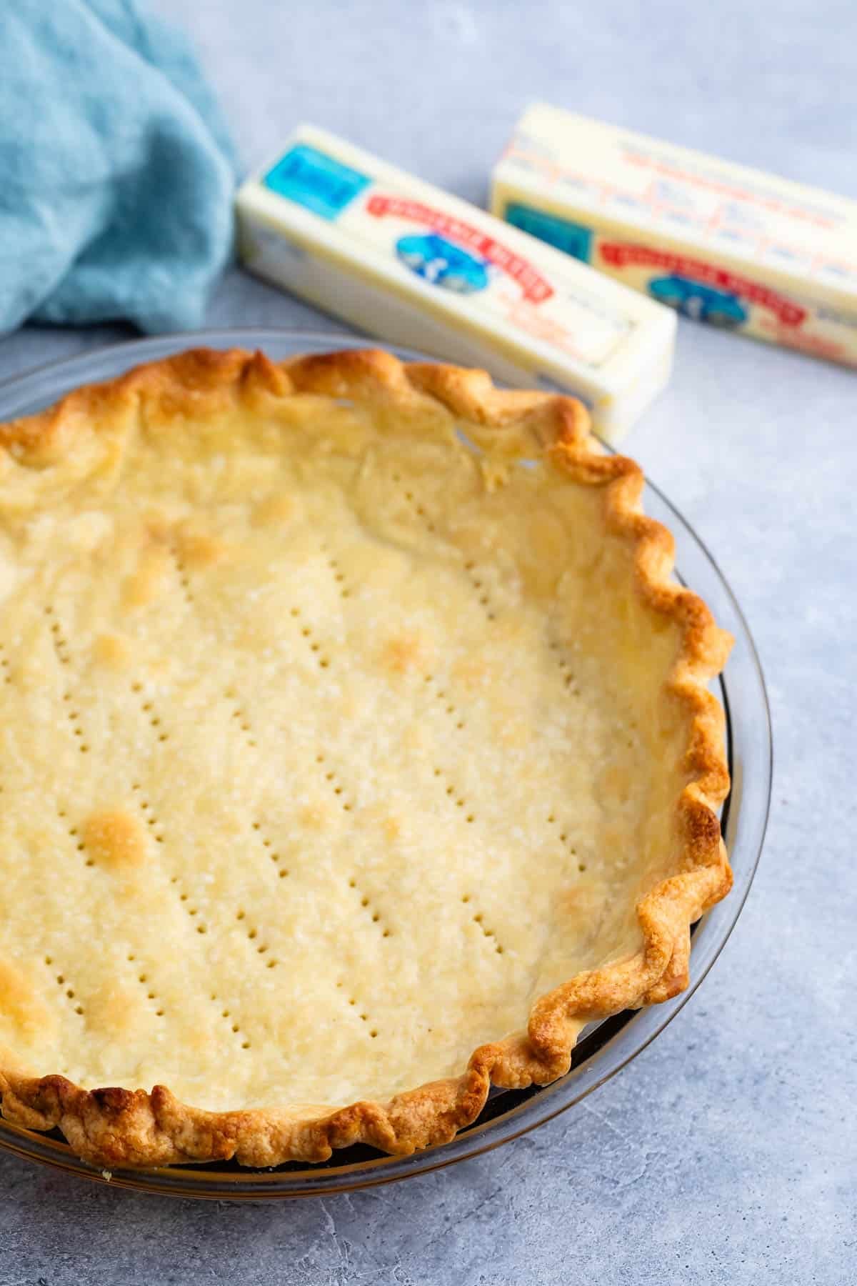 butter pie crust in a clear pan.