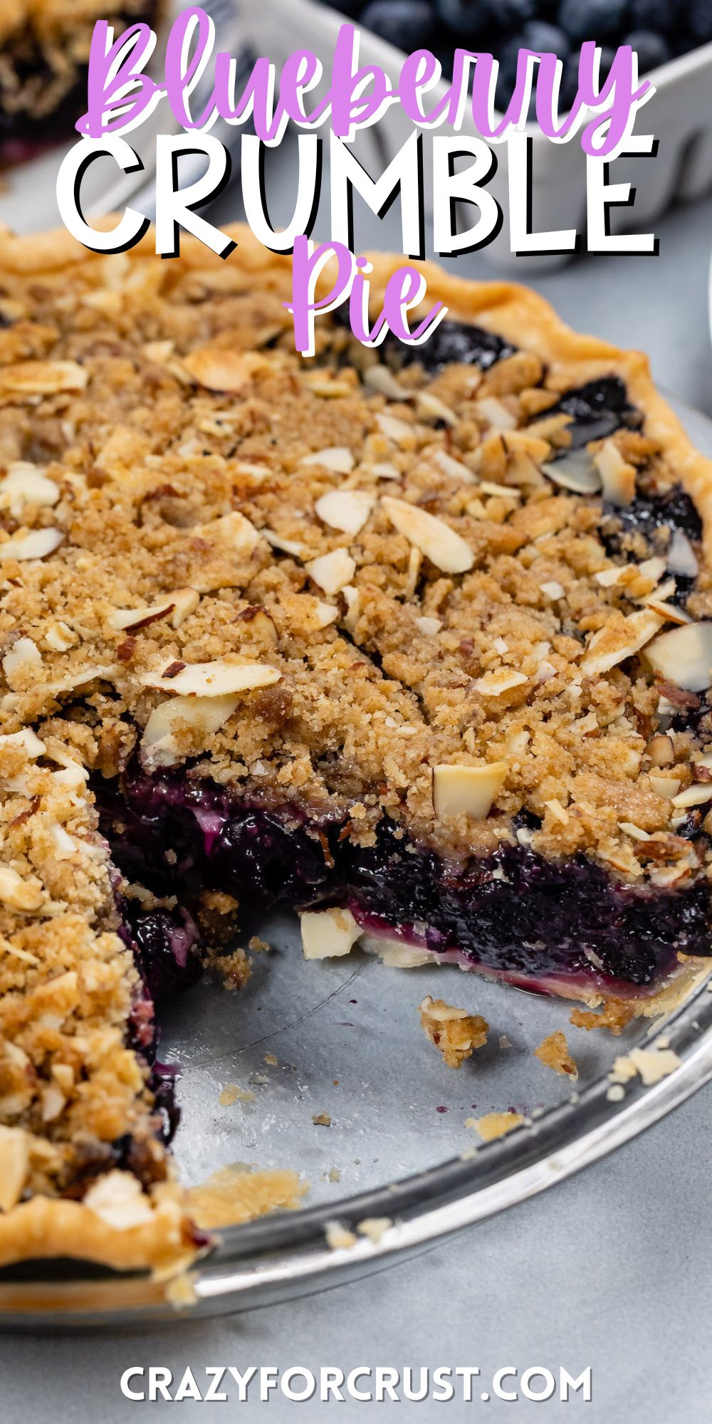 blueberry pie in a clear plate with crumble on top with words on the image.
