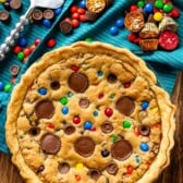 full tan pie with candy baked in and candy around the pie.