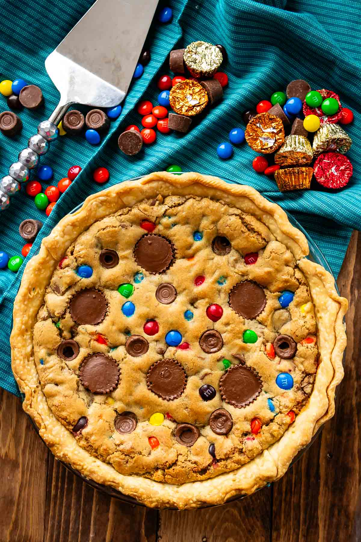 full tan pie with candy baked in and candy around the pie.