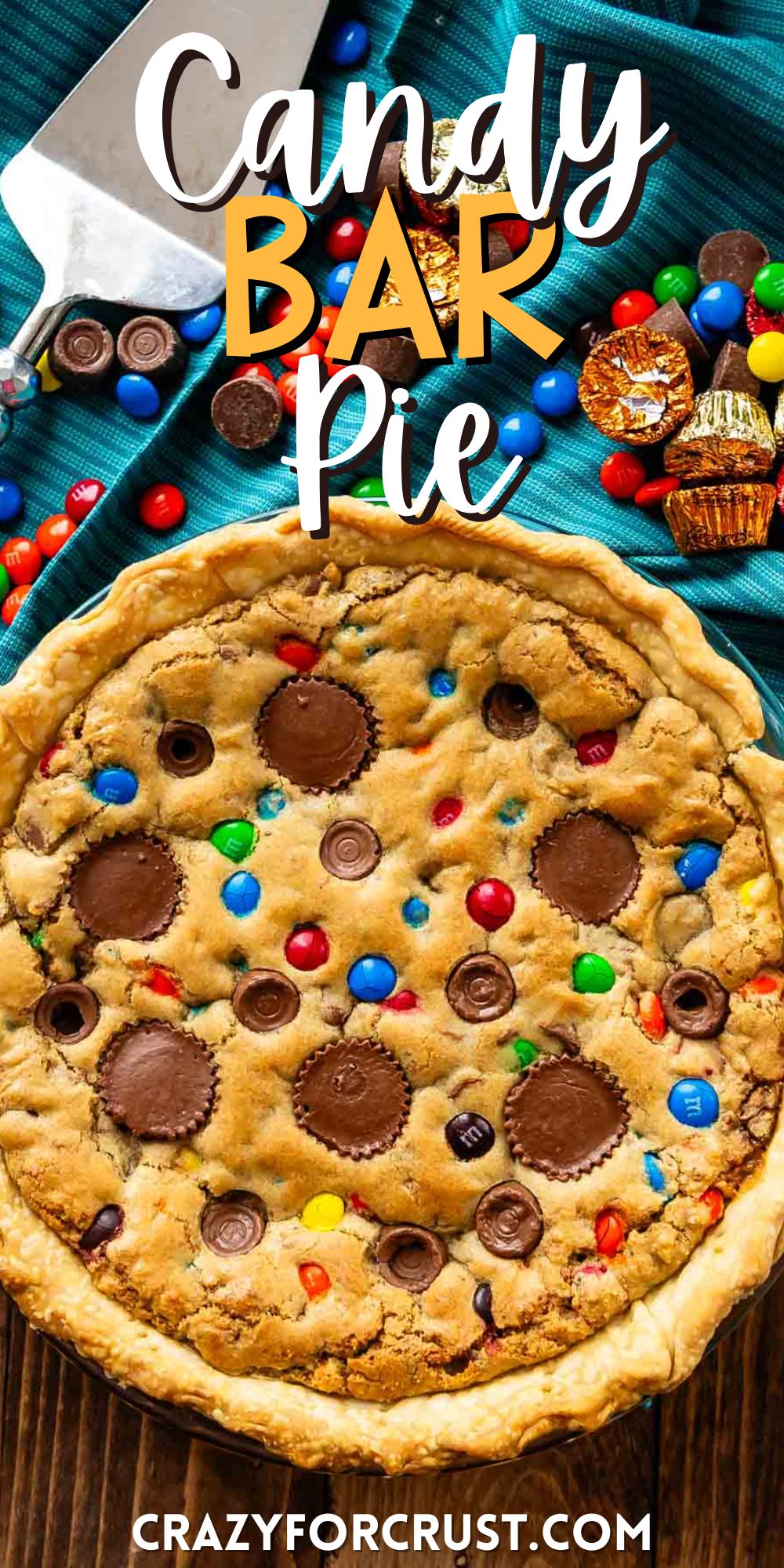 full tan pie with candy baked in and candy around the pie with words on the image.