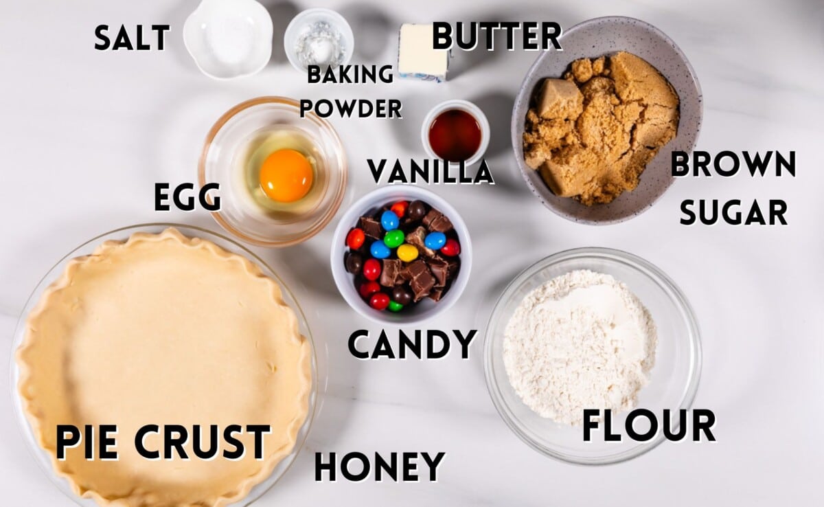 ingredients in candy bar pie laid out on a marble counter.