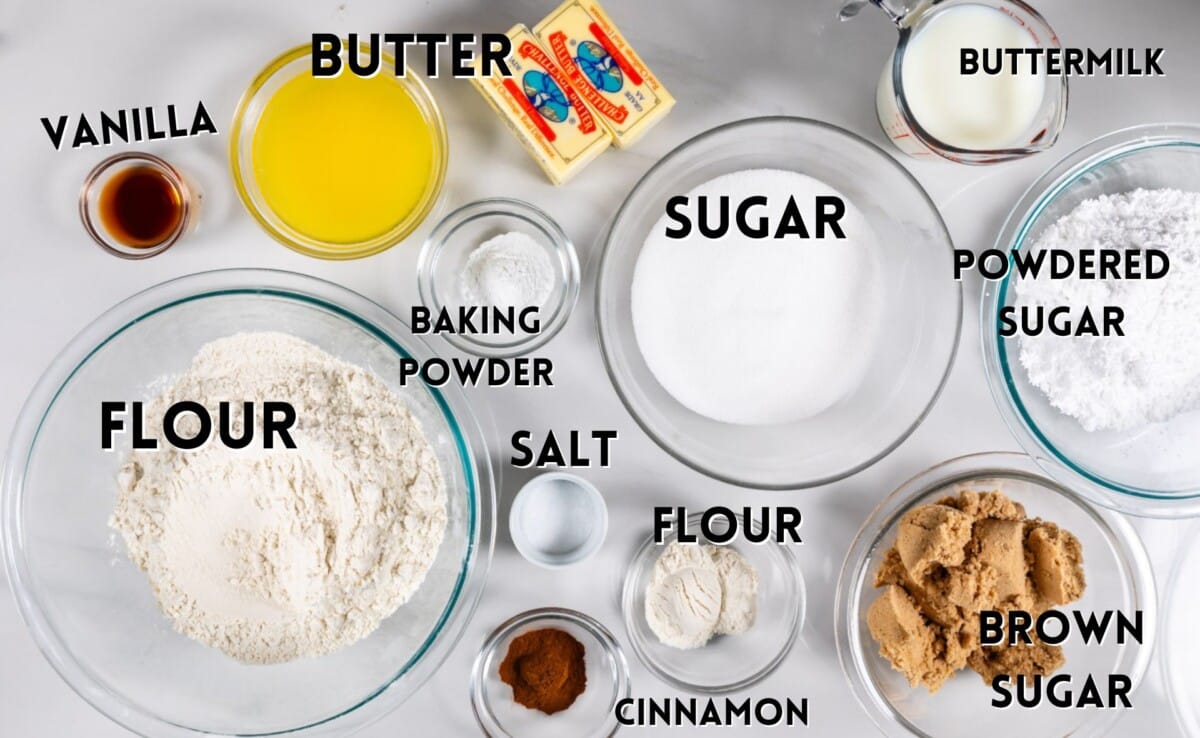 ingredients in cinnamon roll cake laid out on a marble counter.