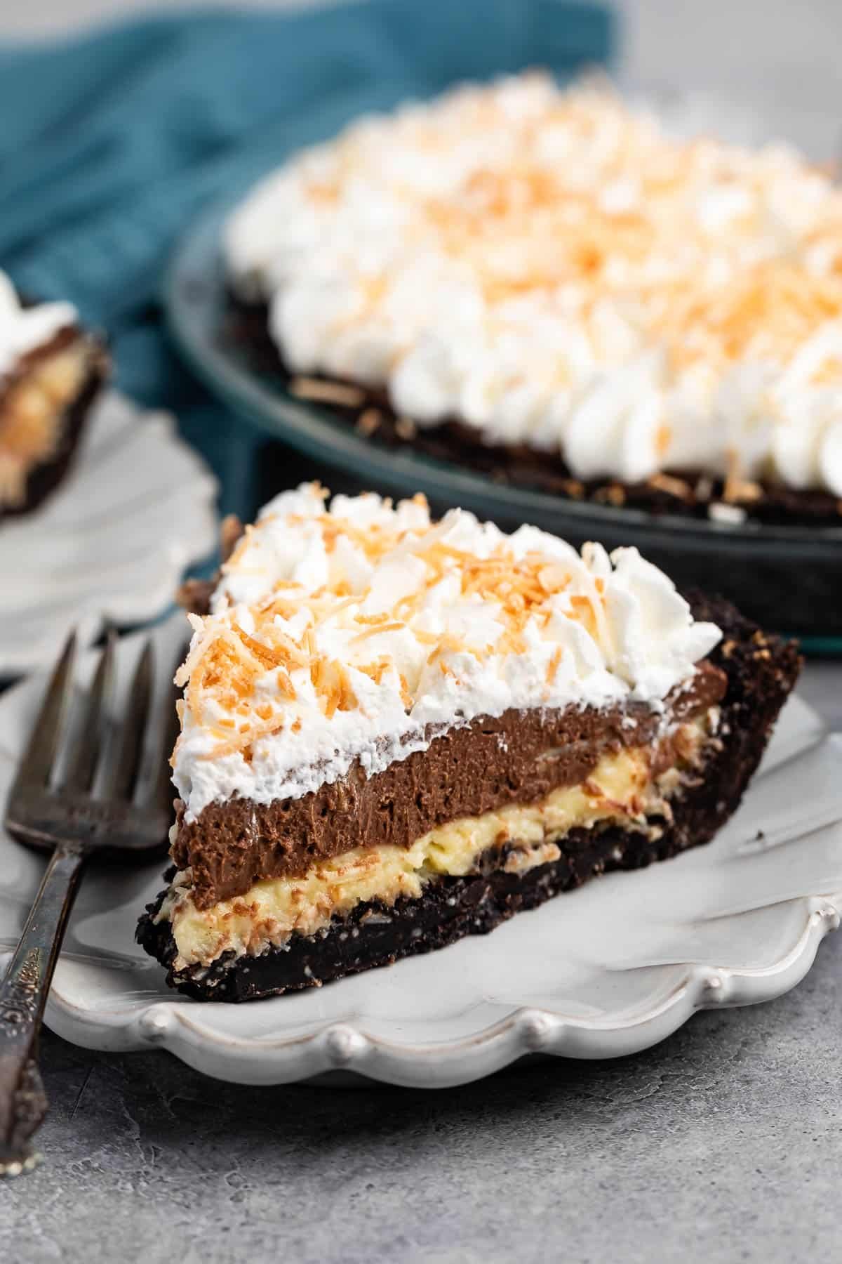 sliced pie with whipped cream and coconut on top.