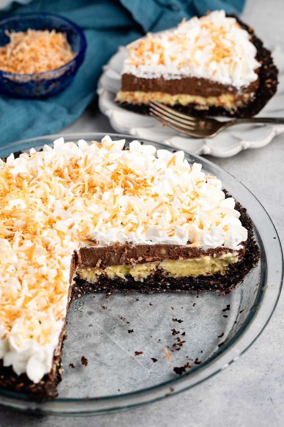 sliced pie with whipped cream and coconut on top.