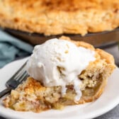 one slice of pie with crumble topping and vanilla ice cream on top.