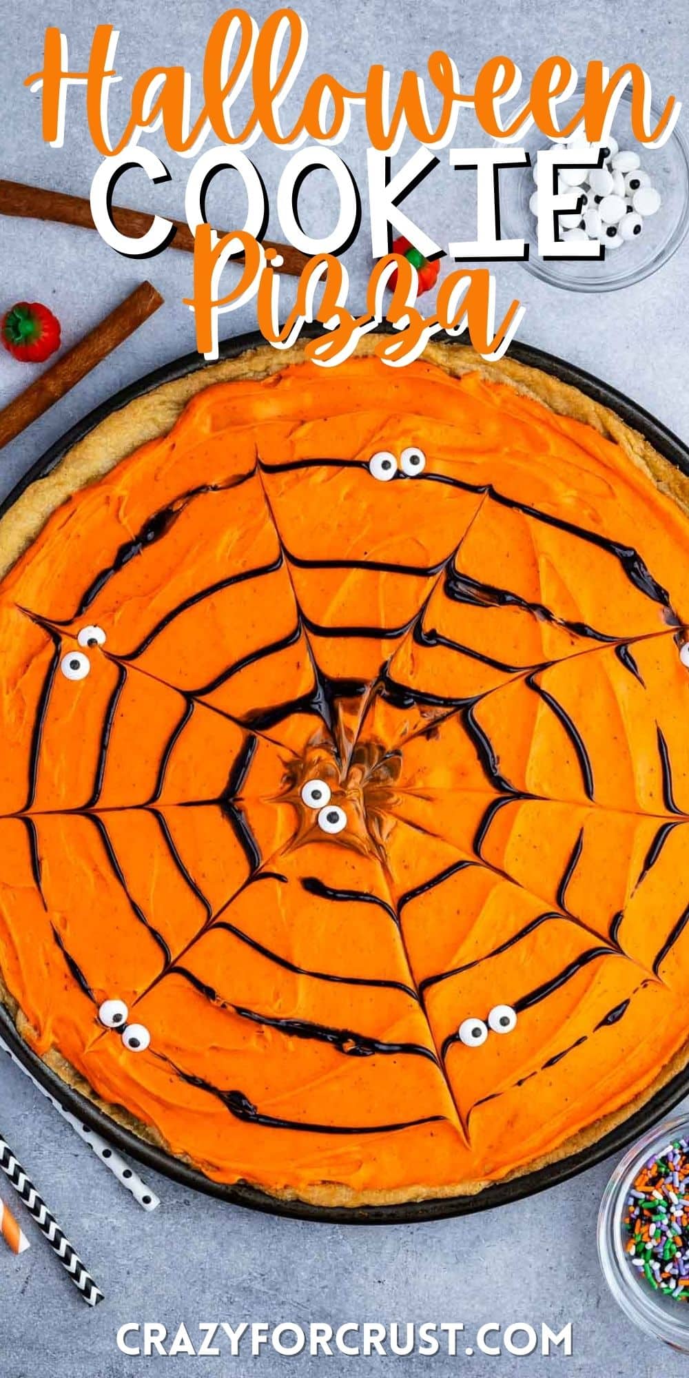 a circle cookie pizza with black frosting forming a spiderweb.