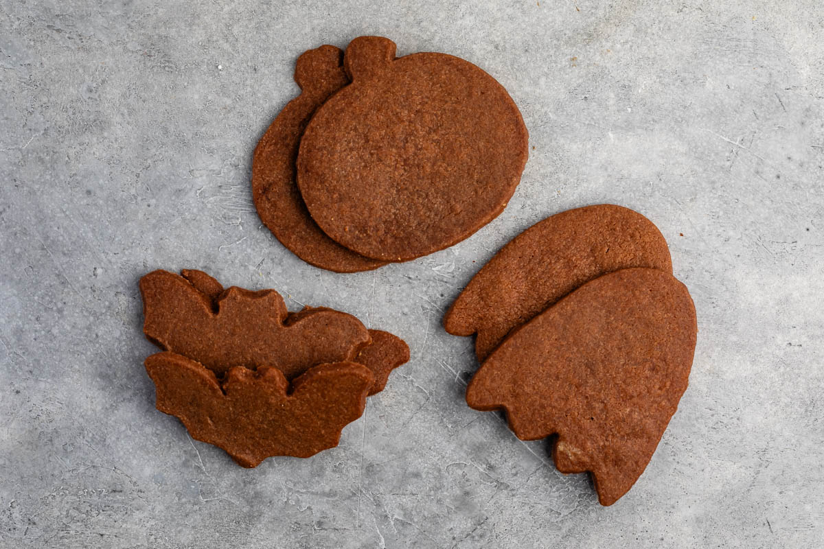 brown sugar cookies shaped like halloween characters on a counter.