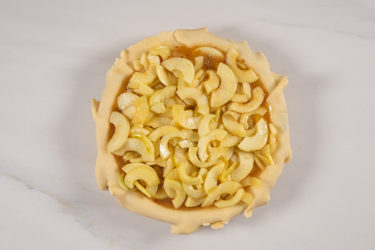 process shot of apple cider pie being made.