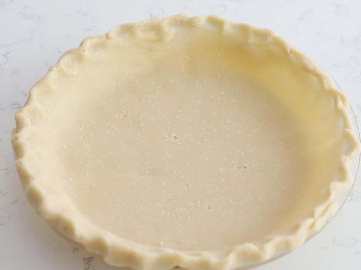 pie crust in pie plate on counter.