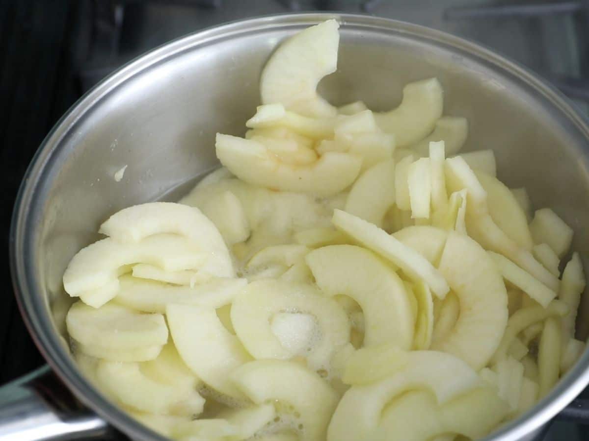cooked apples in pan.