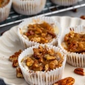 mini pecan pie cheesecake in a white cupcake wrapper.