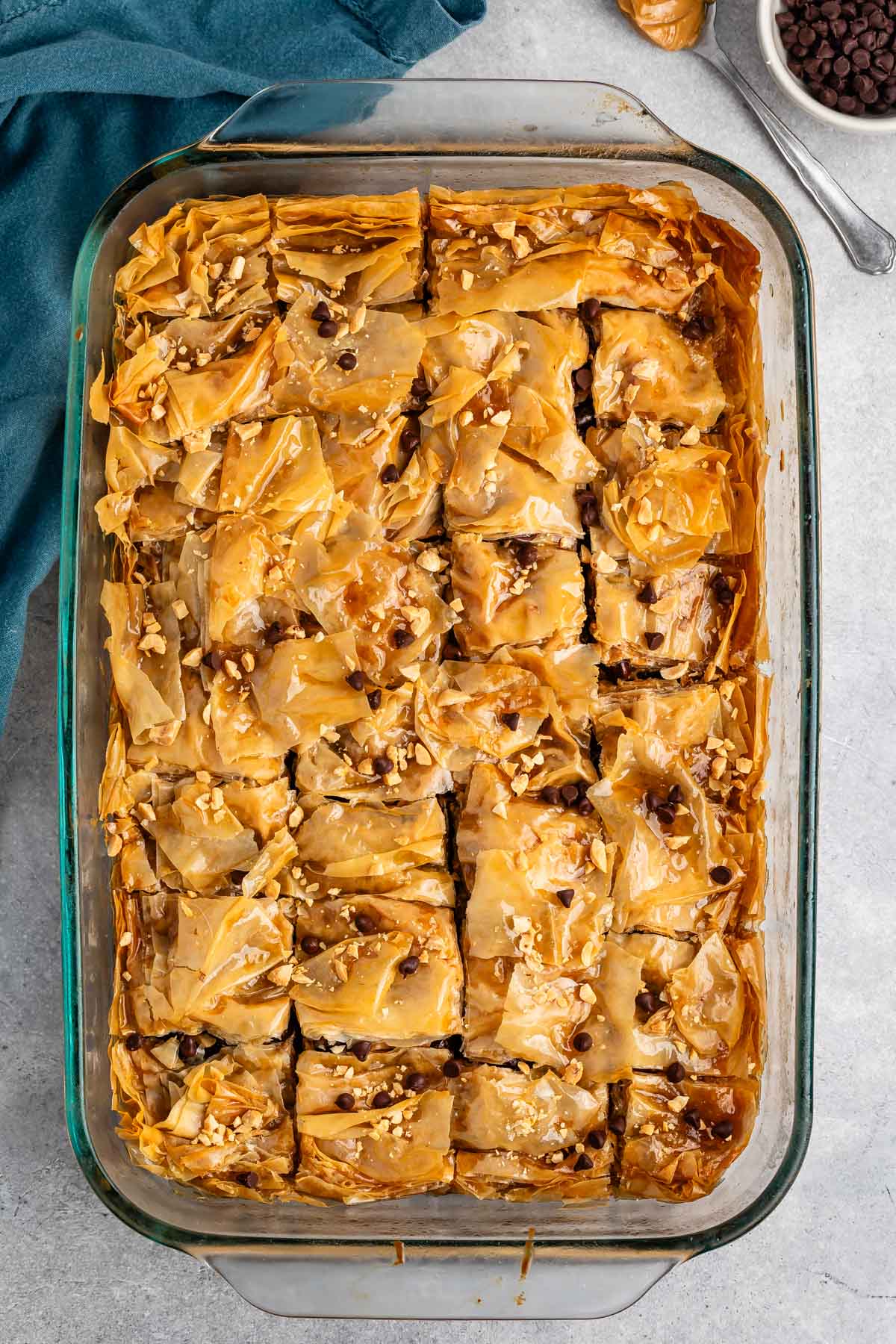 peanut butter baklava mixed with chocolate chips in a clear baking pan.