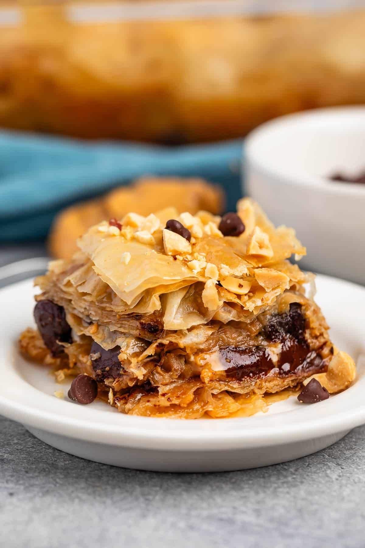 baklava mixed with chocolate chips sitting on a white plate.