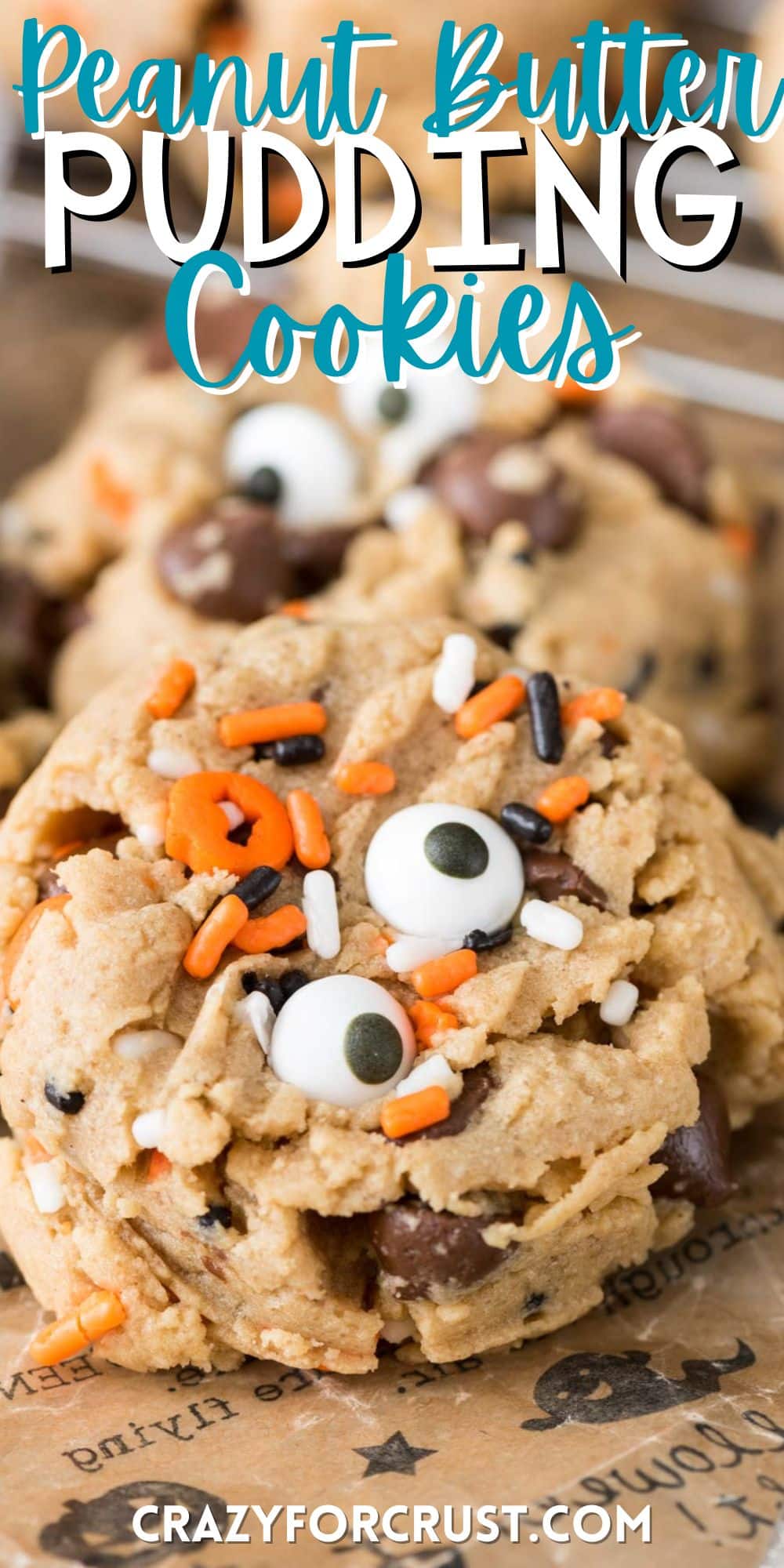 pudding cookies with orange and black sprinkles and candy eyes baked in with words on the image.