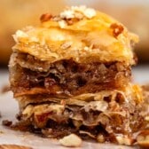 stacked baklava with pecans layered in it.