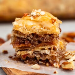 stacked baklava with pecans layered in it.