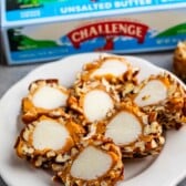 pecan log slices on white plate with challenge butter box behind