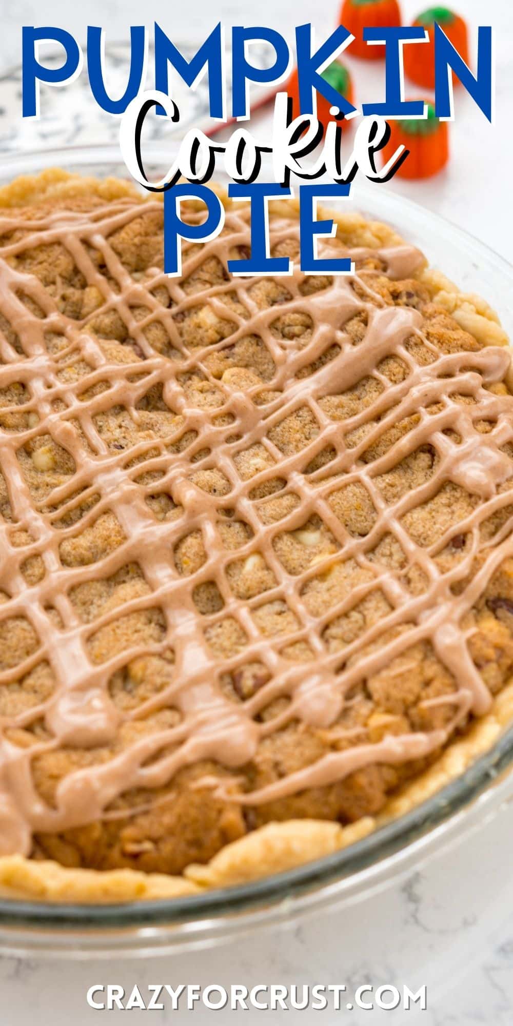 cookie pie in a clear pie pan with glaze drizzled over with words on the image.