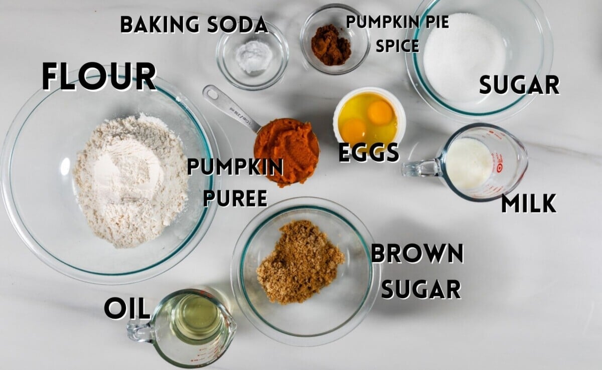 ingredients in pumpkin muffins laid out on a marble counter.