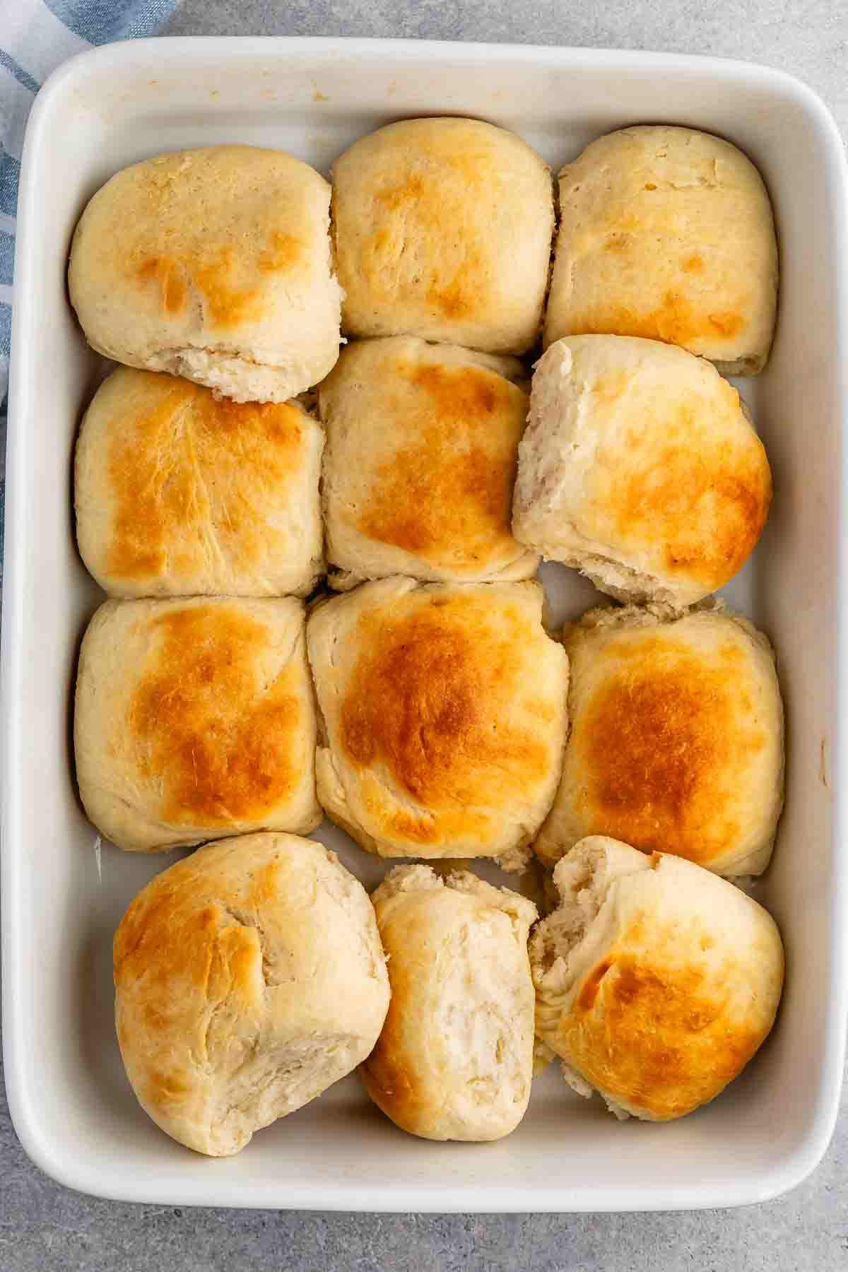 golden rolls in a white glass pan.