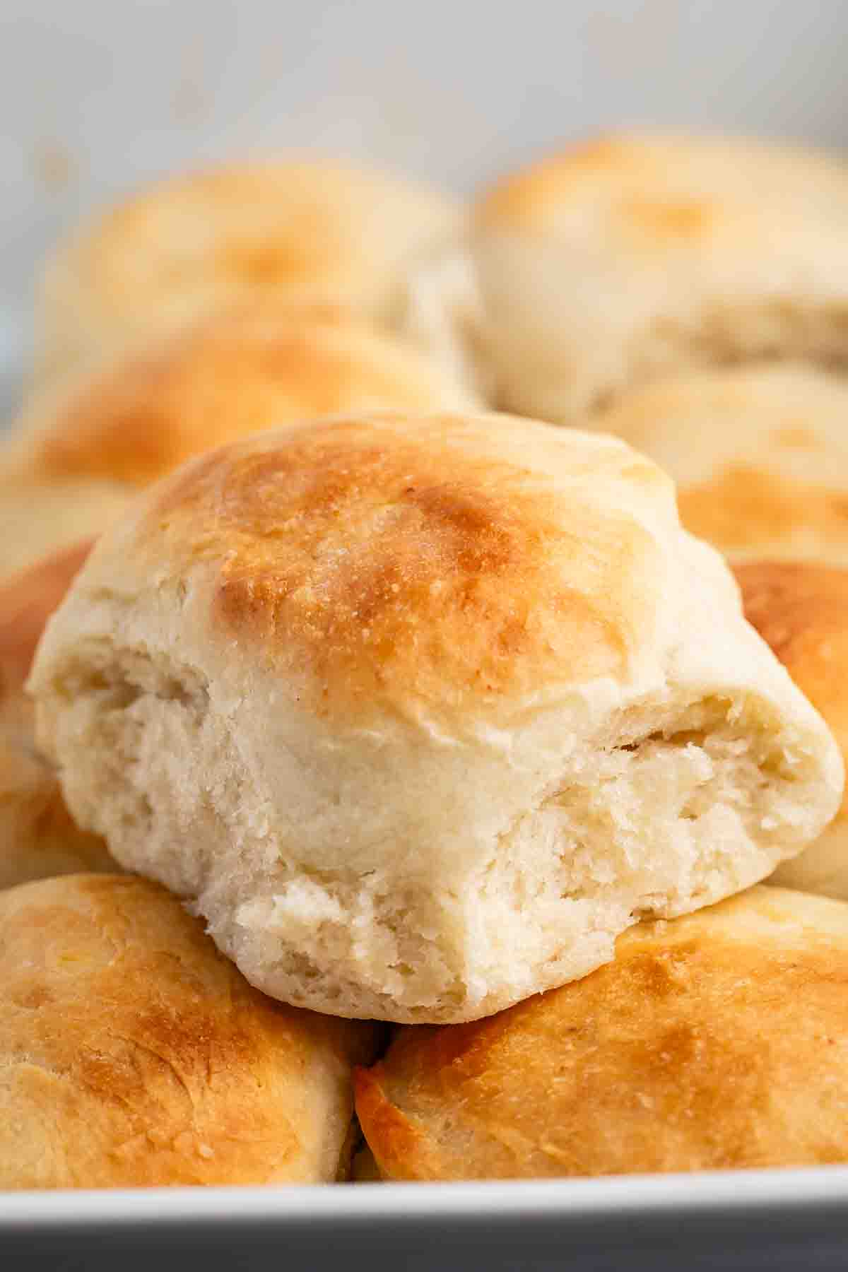 golden rolls in a white glass pan.