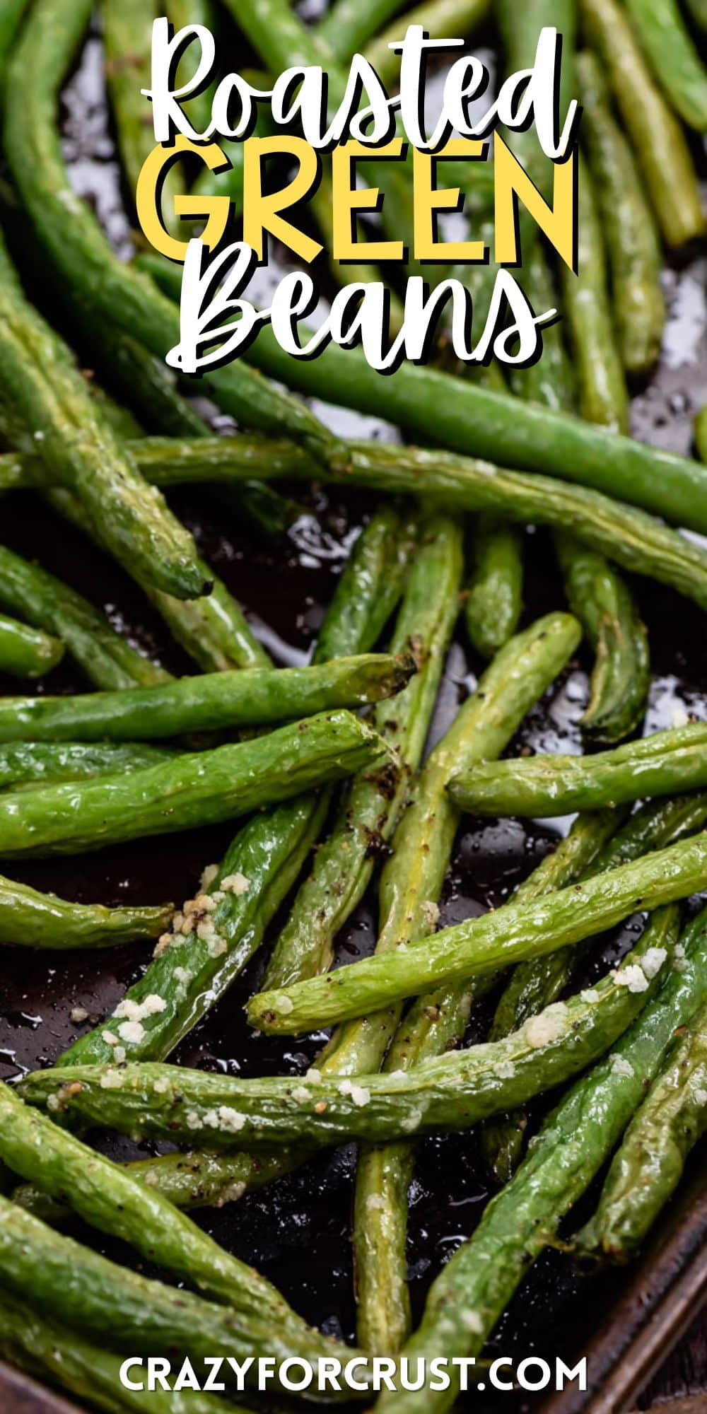 greens beans piled on each other on a black cooking sheet with words on the image.