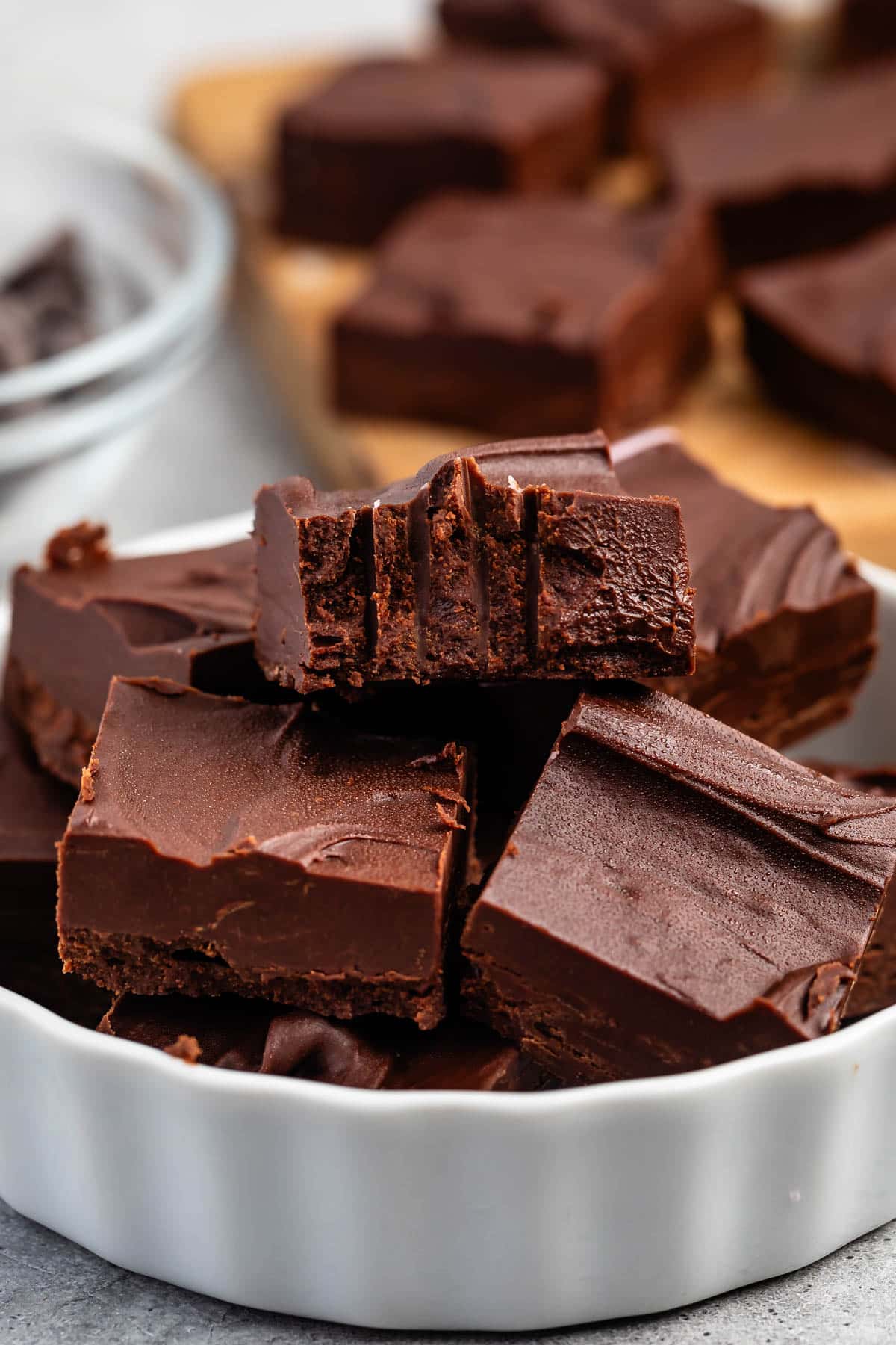stacked brown fudge in a white dish.