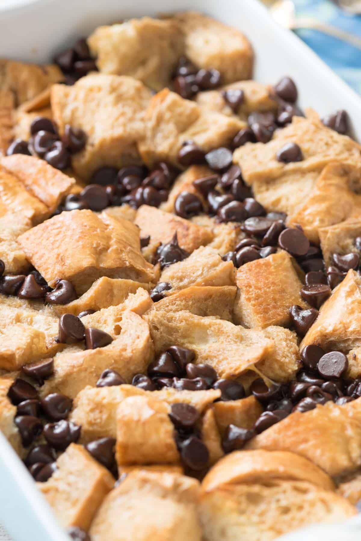 French toast mixed with many chocolate chips in a white dish.