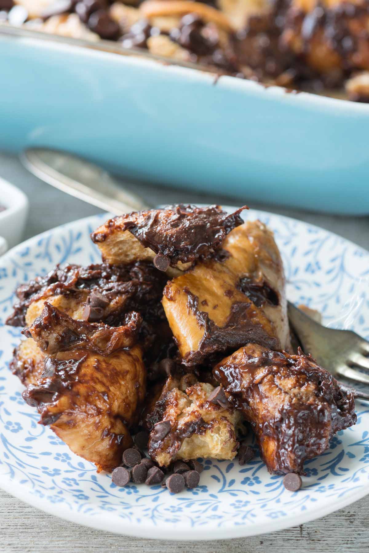 French toast mixed with many chocolate chips in a white dish.