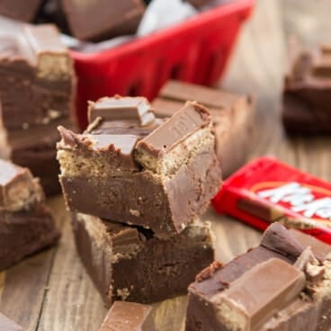 stacked fudge with KitKats on top near wrapped KitKats.