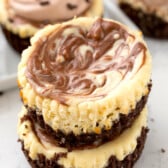 stacked mini circular cheesecakes with white and brown marble on top.