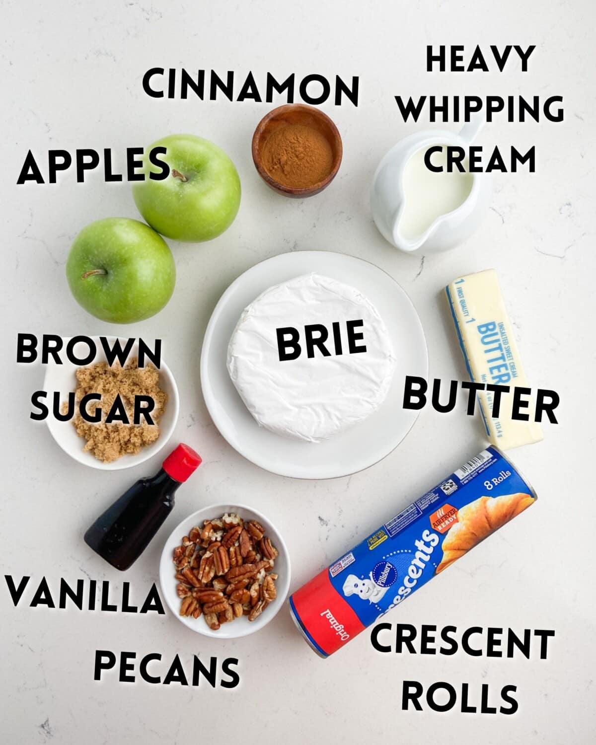 ingredients in baked brie laid out on a marble countertop.