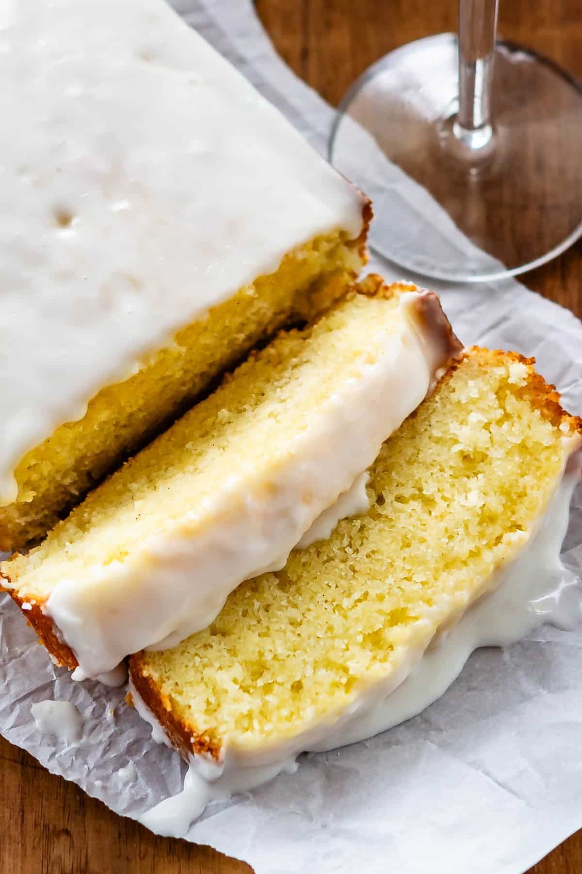 sliced pound cake with icing on top on a white plate.