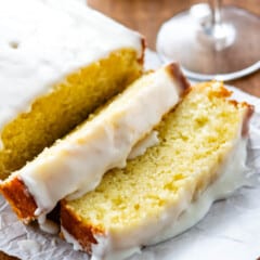 sliced pound cake with icing on top on a white plate.