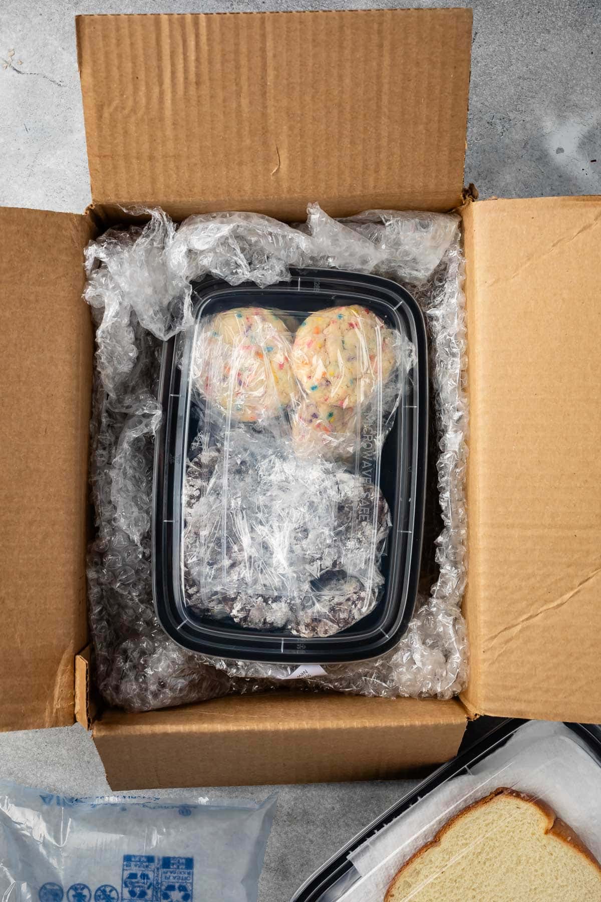 cookie container in cardboard box with bubble wrap.