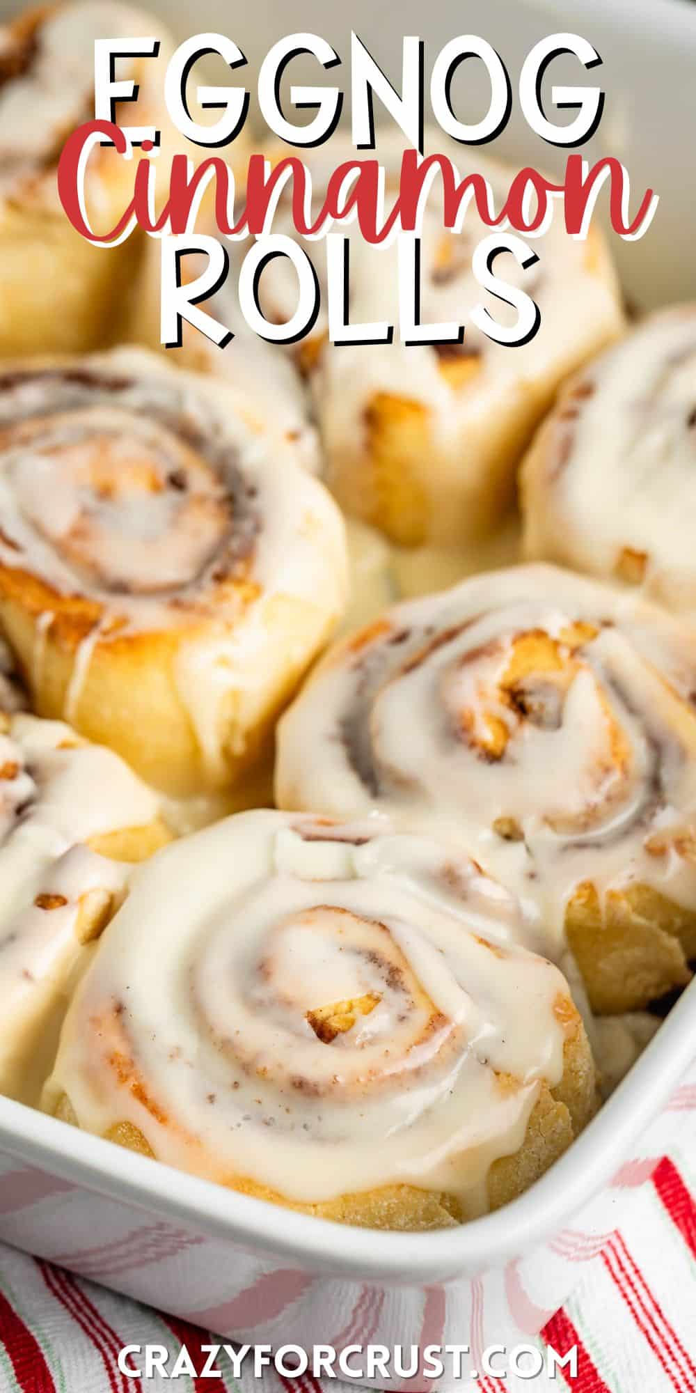 cinnamon rolls laid together in a white dish with icing on top with words on the image.