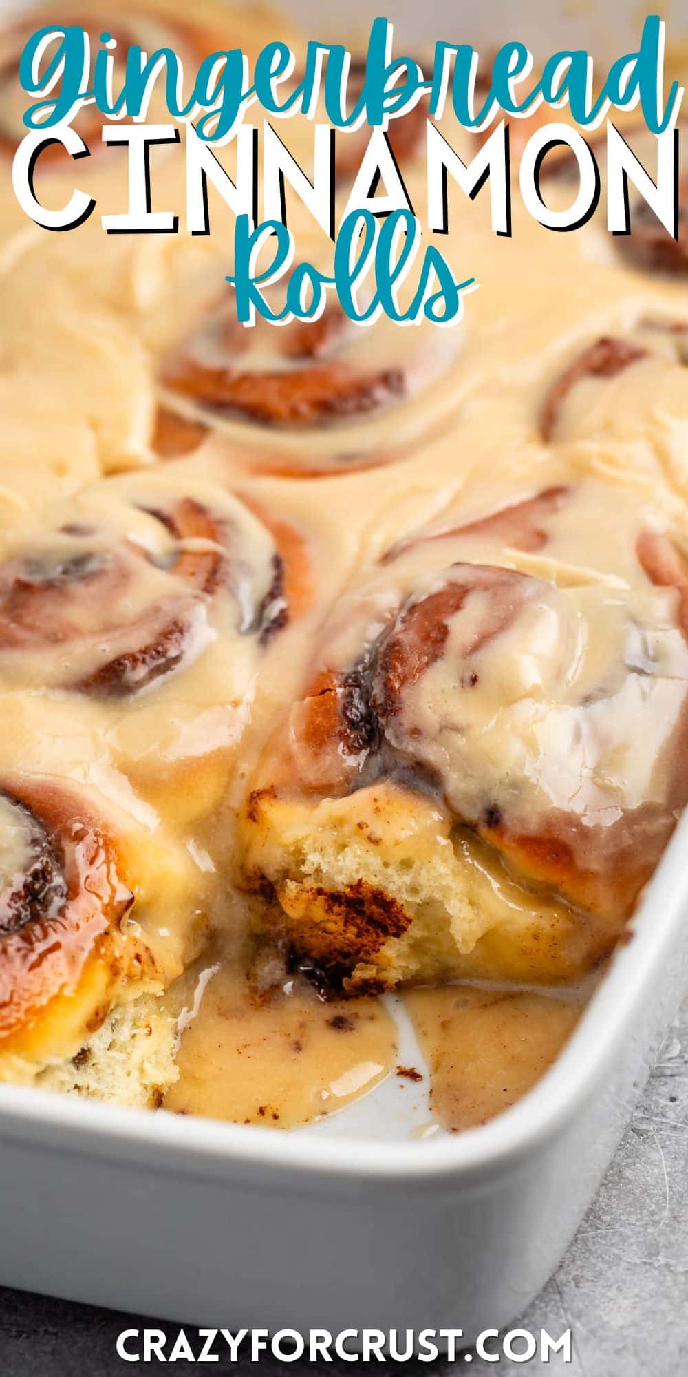 cinnamon roll on a grey plate with icing in top with words on the image.