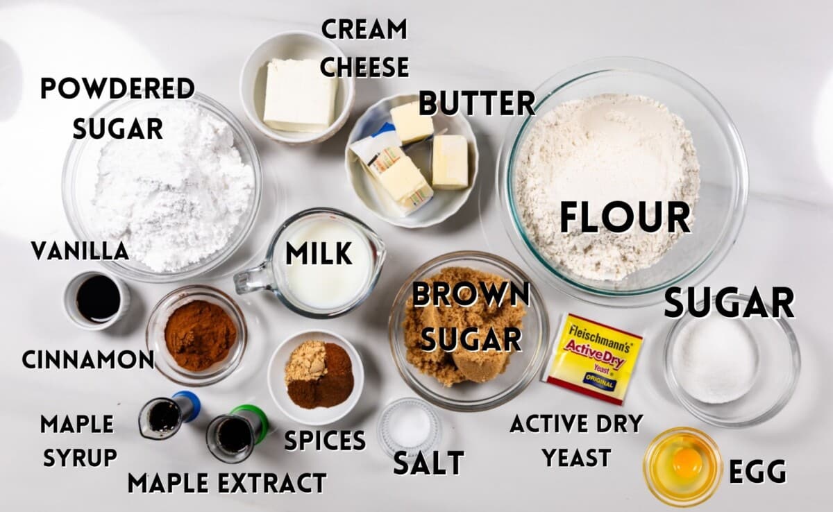 ingredients in gingerbread cinnamon rolls laid out on a marble countertop.