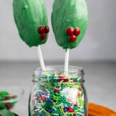 madeleines covered in green chocolate standing up in sprinkles.