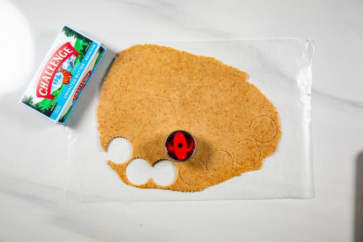 cookie dough on counter with cutter.