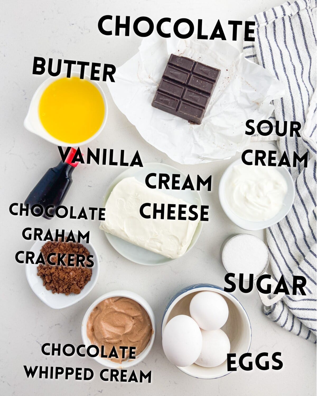 ingredients of mini marble cheesecakes on a marble countertop.