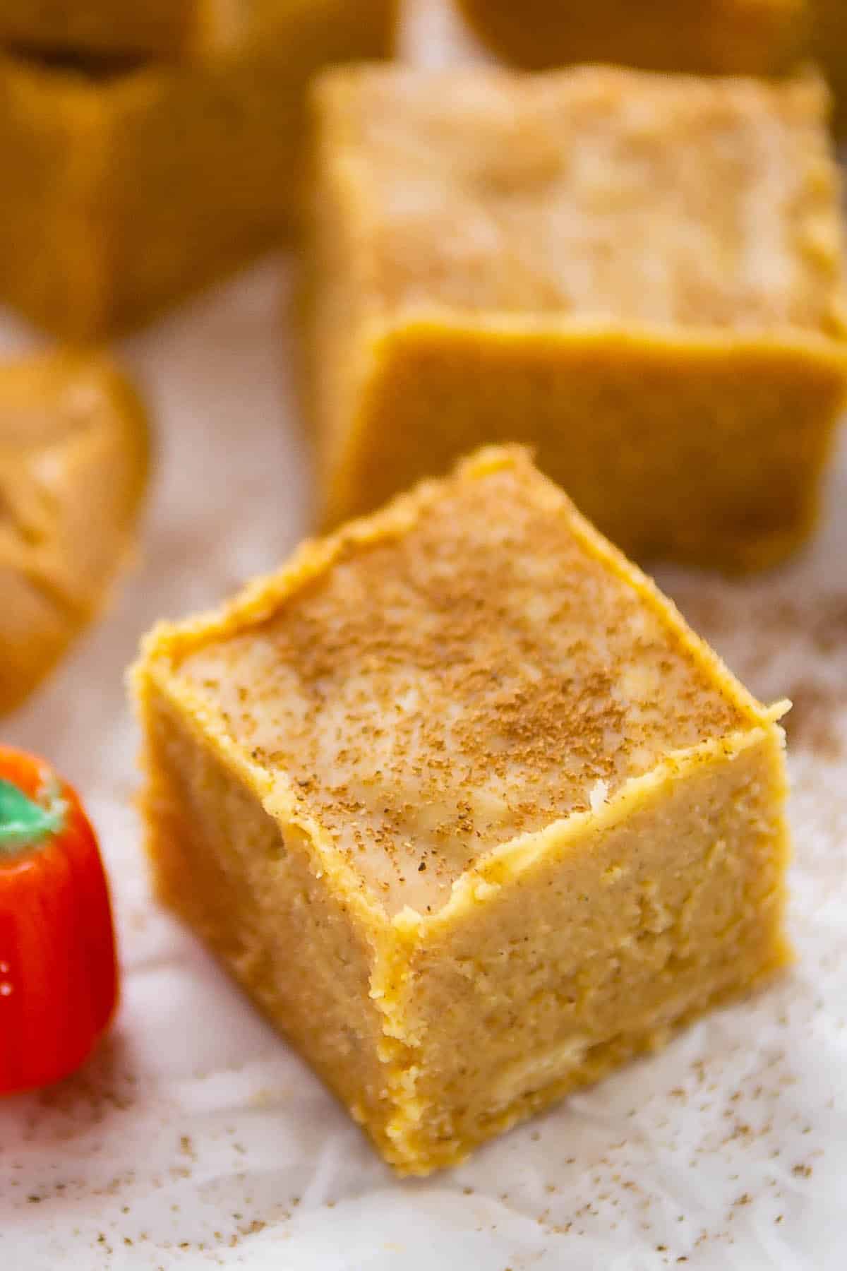 orange fudge with spices sprinkled on top.