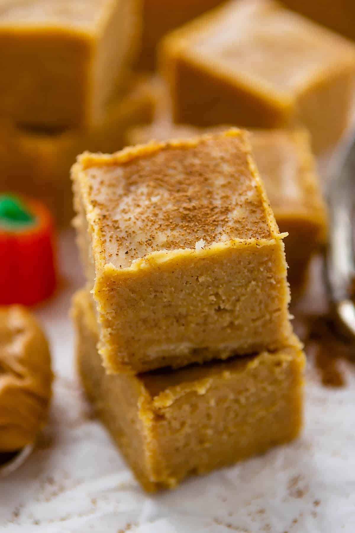 stacked orange fudge with spices sprinkled on top.