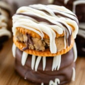 stacked ritz crackers covered in chocolate with cookie dough in the middle.