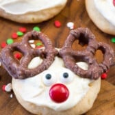 cookie with white frosting and candy on top to make the cookie look like a reindeers face.