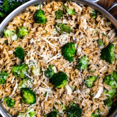 pasta mixed with broccoli in a silver skillet.