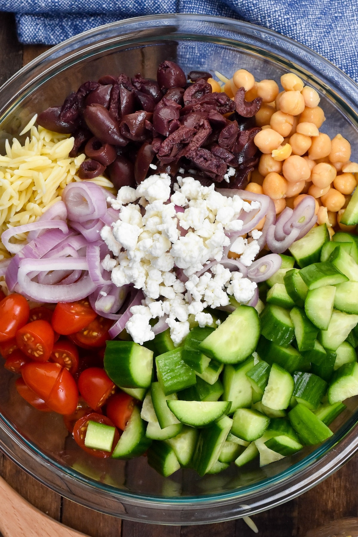 greek salad separated in a clear bowl.