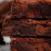 stacked brownies with chocolate chips baked in on the inside.