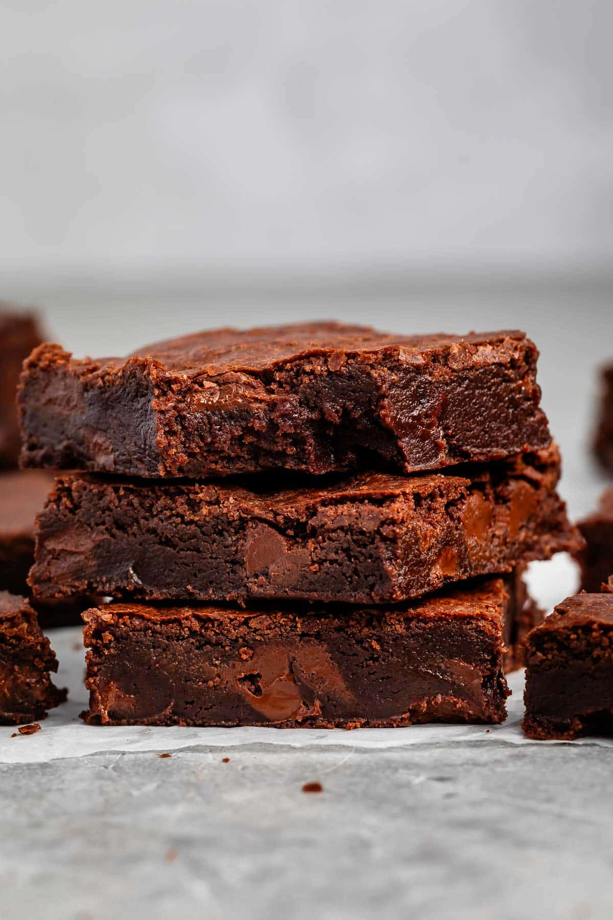 stacked brownies with chocolate chips baked in on the inside.